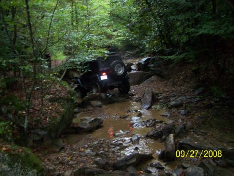 1992 Jeep Cherokee - Jeep Cherokee driving through a challenging off-road stream environment.