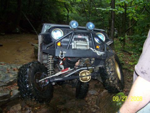 1992 Jeep Cherokee - This 1992 Jeep Cherokee navigates a challenging off-road course with mud and rocks.