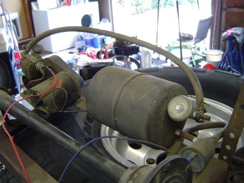 1978 Ford Bronco - Close-up view of an air compressor and tank system, likely an aftermarket addition to a vehicle.