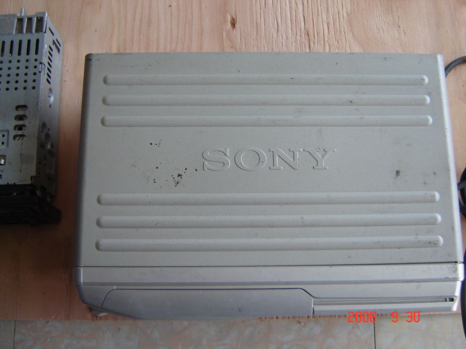 Sony CD changer unit next to a car stereo receiver with visible ports