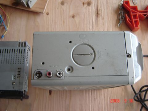1993 Ford Bronco - Two car stereo components are shown on a wooden surface, with one component RCA audio out ports.