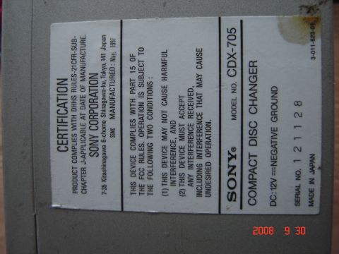 1993 Ford Bronco - A close-up of a label on a Sony CD changer, detailing its model number and certification information.