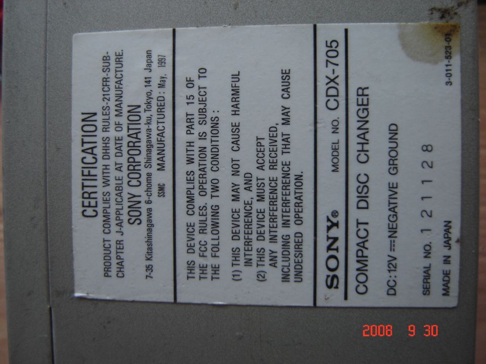 Label on a Sony CD changer showing model number CDX-705 and manufacturing details