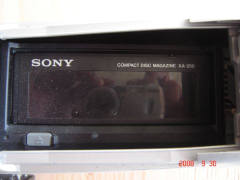 1993 Ford Bronco - Close-up of a Sony CD changer magazine, model XA-250, with a release button visible.