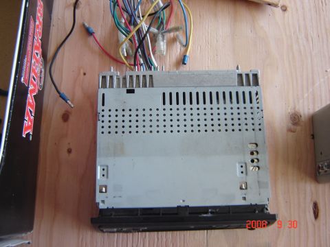 1993 Ford Bronco - A car stereo unit with a bundle of wires is shown on a wooden surface.