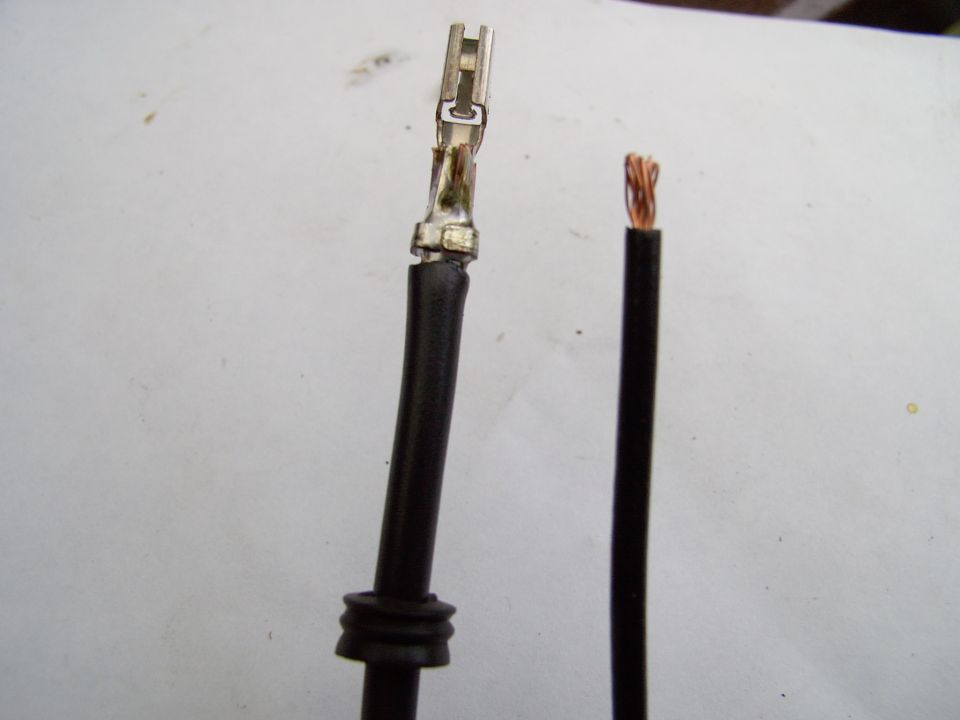 Slip the grommet over the new 10 gauge wire, crimp the outer tangs onto the wire and solder it solid.