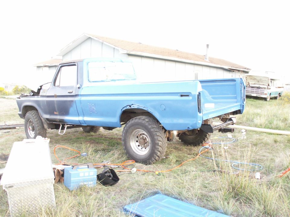 Blue 1977 Ford F-250 pickup truck, rear 3/4 view, parked outdoors