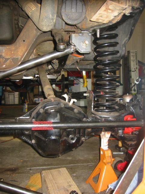 1995 Ford Bronco - The photo shows the underside of a vehicle, focusing on the rear axle and suspension system.
