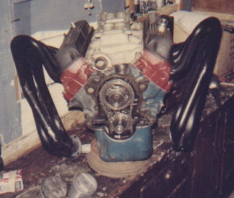 1978 Ford Mustang II - Engine components, including headers and timing gears, are laid out on a workbench.