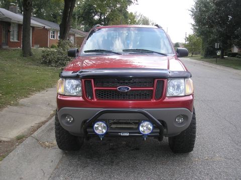 2002 Ford Sport Trac - Front view of a red 2002 Ford Sport Trac, a custom grille and auxiliary lights.