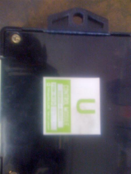 1994 Ford Bronco - Close-up of an electronic control unit with a label that has some readable text.