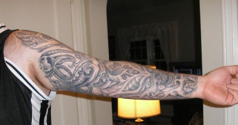 1995 Ford Bronco - Full sleeve tattoo biomechanical elements and a skull design.