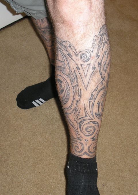 1995 Ford Bronco - Close-up of tribal-style tattoo art covering a person's leg.