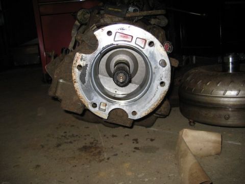 1995 Ford Bronco - Close-up view of a transmission housing and a torque converter, likely for a vehicle repair or parts catalog.
