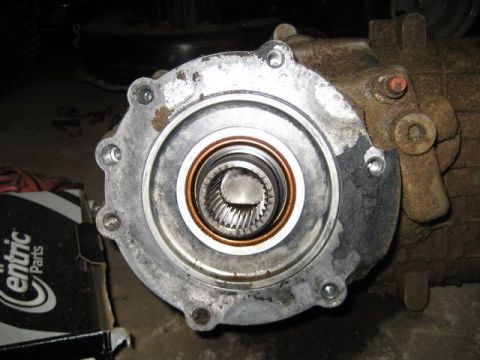 1995 Ford Bronco - Differential housing with splined output shaft, next to a box of Centric Parts.