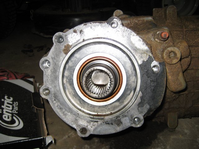 Close-up of a differential housing showing a splined output shaft and mounting bolts. A box labeled 'Centric Parts' is visible to the left
