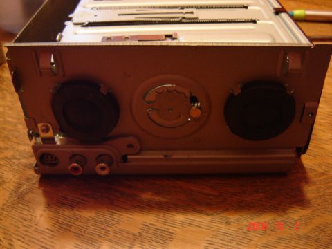 1993 Ford Bronco - A car CD changer with RCA audio outputs and two black circular connectors is shown.
