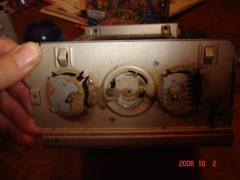 1993 Ford Bronco - A CD changer component, possibly from a vehicle, is shown from the rear with visible mechanical parts.