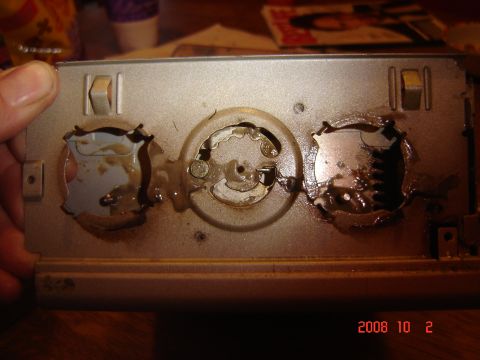 1993 Ford Bronco - Close-up of a CD changer mechanism, showing its internal components and switches.