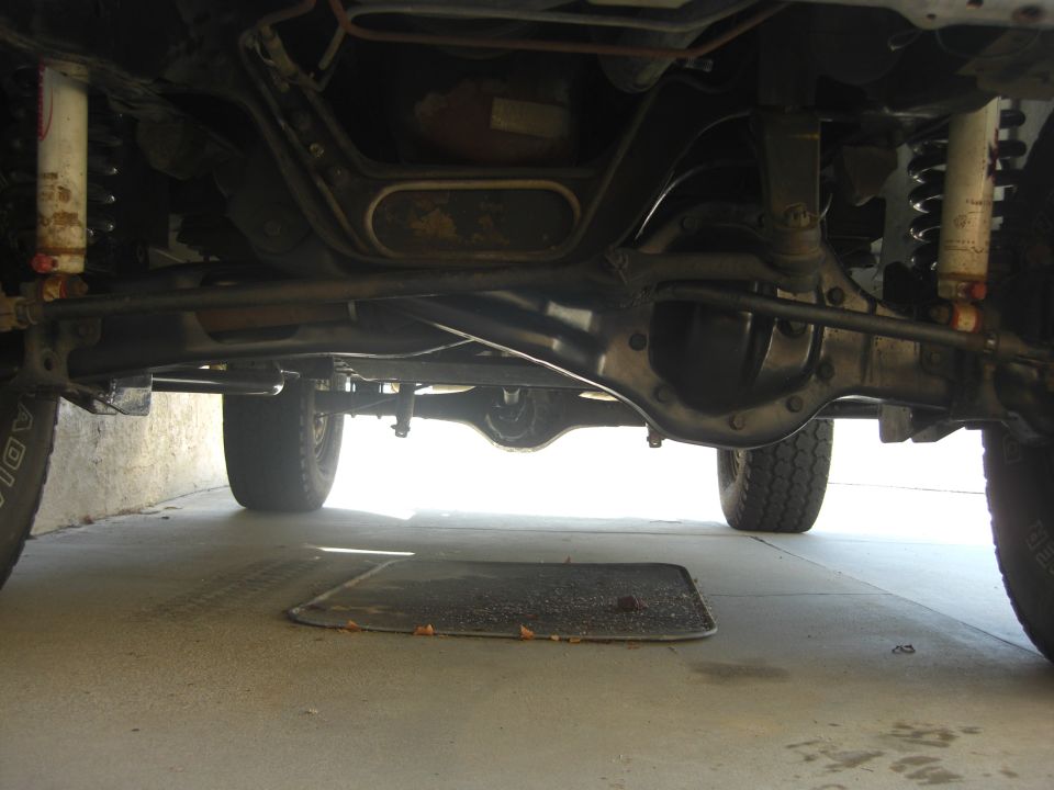 Undercarriage view of a 1984 Ford Bronco showing suspension and drivetrain components