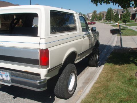 1987 Ford Bronco - Rear view of a 1987 Ford Bronco parked on a residential street.