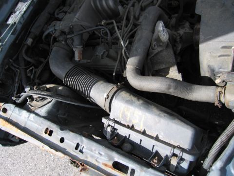 1991 Ford LTD Crown Victoria - Close-up view of the engine bay, showing the air intake system and various engine parts.