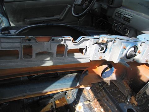 1991 Ford LTD Crown Victoria - The interior of a car shows significant damage and rust on the dashboard and floor.