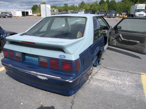 1991 Ford LTD Crown Victoria - This Ford Mustang has a two-tone paint scheme and its driver's door is ajar.