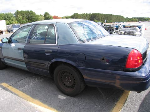 1991 Ford LTD Crown Victoria - Side view of a 1991 Ford Crown Victoria LTD with two-tone paint and a bullet hole.