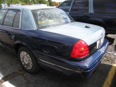 1991 Ford LTD Crown Victoria - Rear view of a two-tone Ford Crown Victoria sedan with white markings on the rear window.