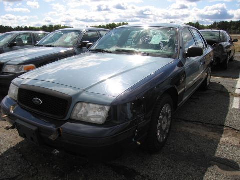 1991 Ford LTD Crown Victoria - A 1991 Ford Crown Victoria LTD is seen in a lot with other vehicles. The front passenger side is visible, showing a two-tone paint scheme.