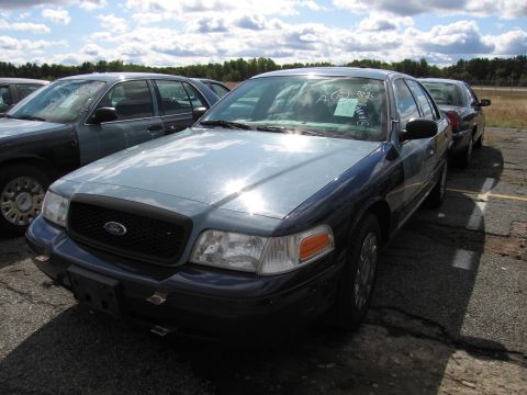 1991 Ford LTD Crown Victoria - Two-tone Ford Crown Victoria sedan parked outdoors with other vehicles in the background.