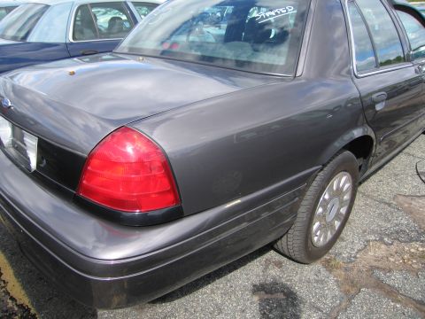 1991 Ford LTD Crown Victoria - Rear quarter view of a 1991 Ford Crown Victoria LTD, parked next to another vehicle.