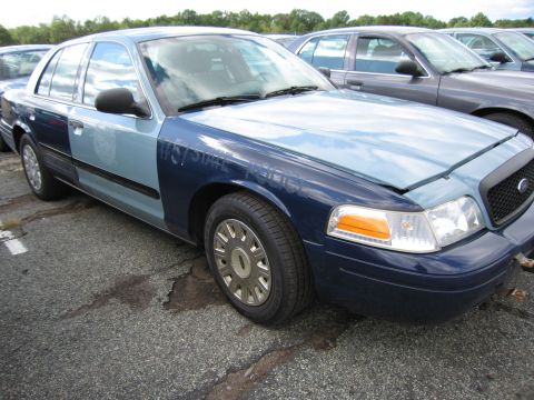 1991 Ford LTD Crown Victoria - Ford Crown Victoria with mismatched paint panels and visible "STATE POLICE" text.