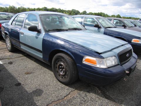 1991 Ford LTD Crown Victoria - A row of Ford Crown Victorias, some with two-tone paint, are parked outdoors.