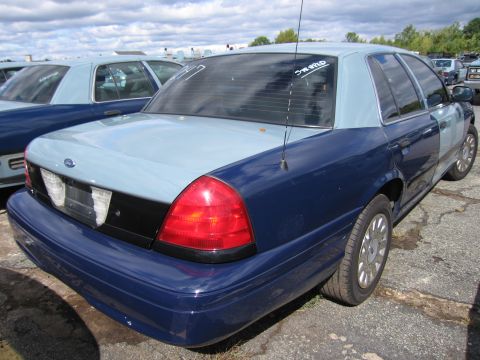 1991 Ford LTD Crown Victoria - This 1991 Ford Crown Victoria LTD features a distinctive two-tone blue and light blue paint job, seen parked alongside other similar vehicl…