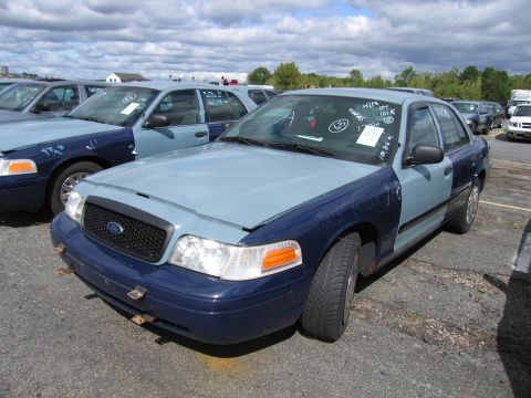 1991 Ford LTD Crown Victoria - This Ford Crown Victoria has a two-tone paint job and appears to be in a vehicle lot with other similar cars.
