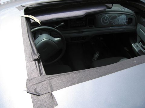 1991 Ford LTD Crown Victoria - Interior view of a 1991 Ford Crown Victoria LTD, showing graffiti and a damaged sunroof.