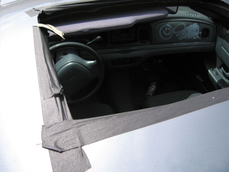 1991 Ford Crown Victoria LTD interior with graffiti on dashboard, duct tape around sunroof opening