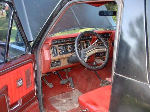 1986 Ford Bronco - Interior view of a 1986 Ford Bronco, highlighting the dashboard and seating.