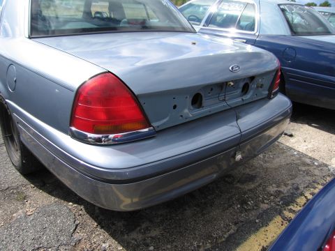 1991 Ford LTD Crown Victoria - Rear view of a light blue 1991 Ford Crown Victoria LTD, showing its taillights and trunk area.