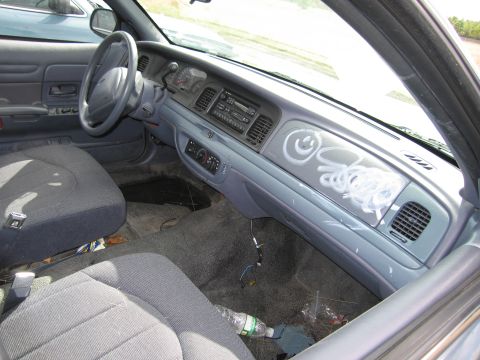 1991 Ford LTD Crown Victoria - Graffiti covers the dashboard of this 1991 Ford Crown Victoria LTD, obscuring the interior details.