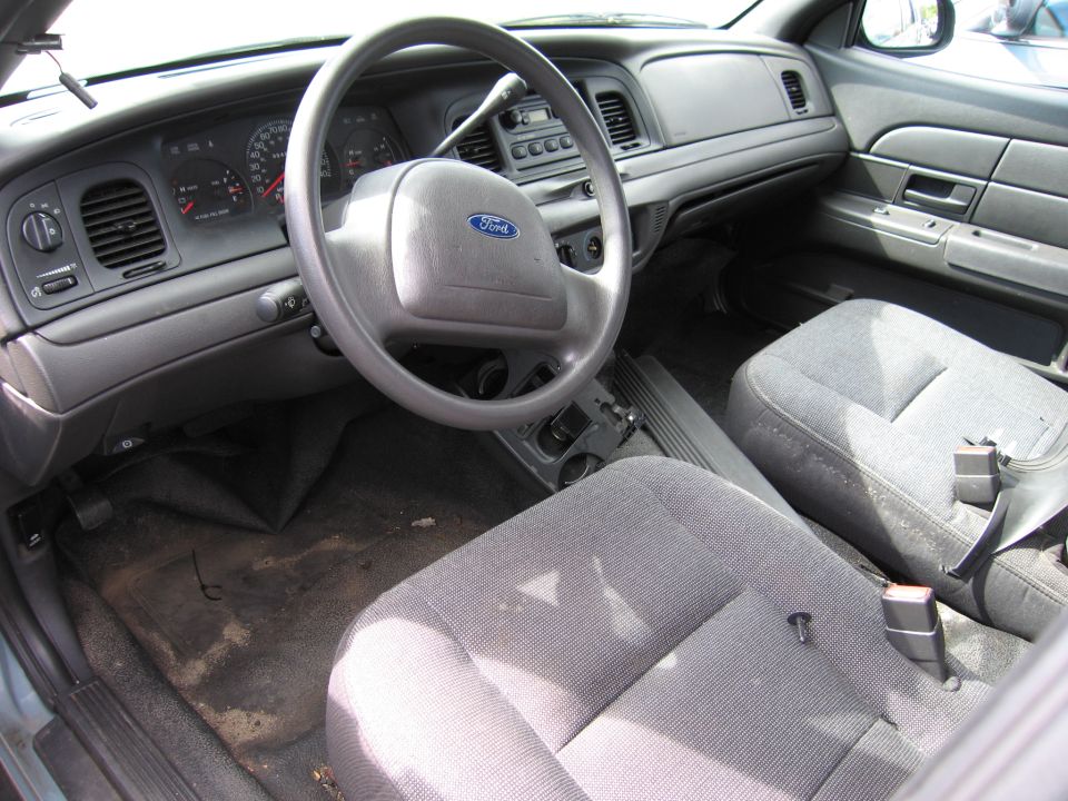 Interior of a car showing dashboard, steering wheel, and seats