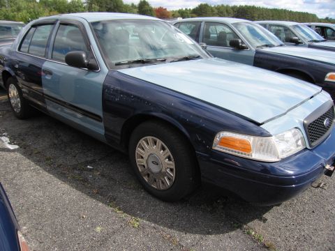 1991 Ford LTD Crown Victoria - Two-tone Ford Crown Victoria, likely from the early 2000s, parked in a lot with other vehicles.