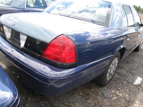 1991 Ford LTD Crown Victoria - A blue Ford Crown Victoria is parked next to another vehicle.