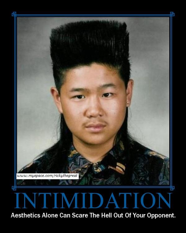 guy with a tall flat top and mullet haircut, wearing a patterned shirt. Text says 'INTIMIDATION'