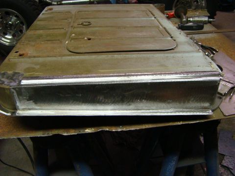 1948 Jeep Wrangler - Metal panel undergoing repair work, showing signs of rust and welding.