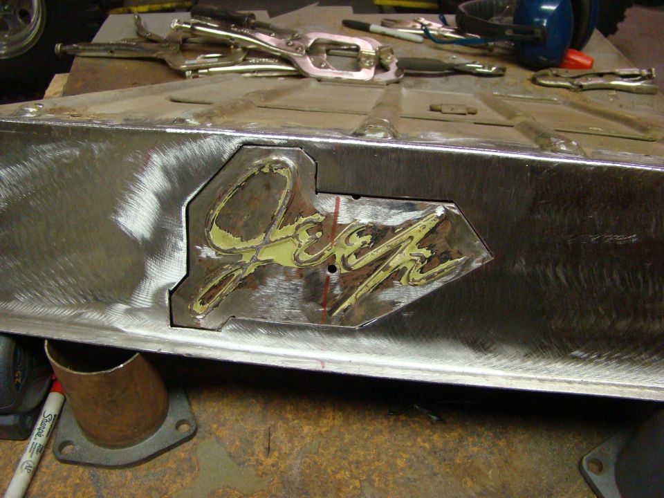 Jeep logo on a metal panel, likely part of bodywork restoration