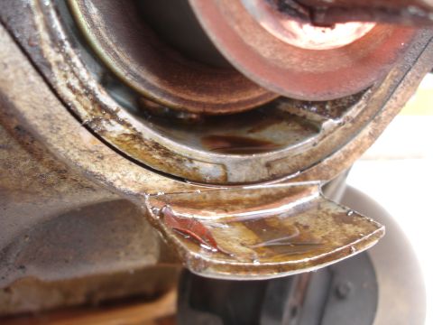 1993 Ford Taurus - Close view of a mechanical part showing wear and oil accumulation.