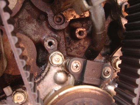 1993 Ford Taurus - This is a close-up view of an engine's timing belt system, showing gears and a sensor.